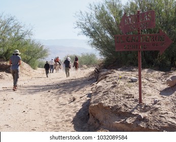 Boquillas Del Carmen, Coahuila / Mexico - Circa November 2017: American Tourists Hiking or Riding Donkeys from the Border into Town