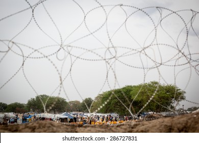 Bor, South Sudan - February 25, 2014: Internally Displaced South Sudanese People Wait For Water In A Refugee Camp