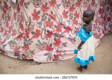 Bor, South Sudan - February 25, 2014: A South Sudanese Girl Walks Around A Refugee Camp