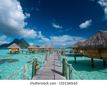 BORA BORA, FRENCH POLYNESIA - SEPTEMBER 5, 2018 - Luxury overwater villas white sandy beach and Otemanu mountain at Bora Bora island, Tahiti, French Polynesia