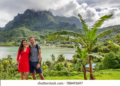 Bora Bora Luxury Cruise Travel Vacation Tourists Couple In Front Of Mt Otemanu In French Polynesia. Tahiti Getaway Holiday People Visiting The Island During Cruise Excursion Tour.