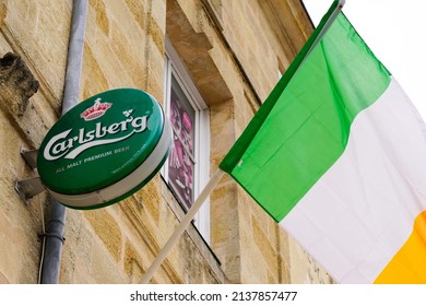 Bordeaux , Aquitaine  France - 03 20 2022 : Carlsberg beer irish flag sign text and brand logo on facade wall building bar pub restaurant