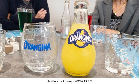 Bordeaux , Aquitaine France  - 07 04 2021 : Orangina Orange Lemonade Logo Sign And Brand Text On Bootle With Empty Soda Glass