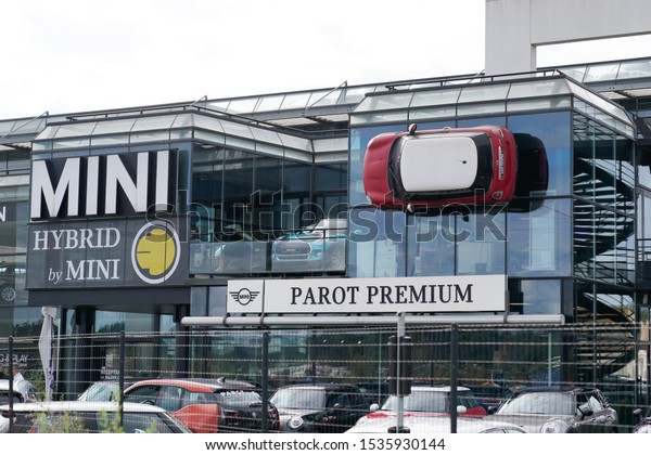 Bordeaux , Aquitaine / France - 10 17 2019 : Mini\
red car is fixed into building wall at BMW Mini Cooper dealership\
dealership shop logo\
sign
