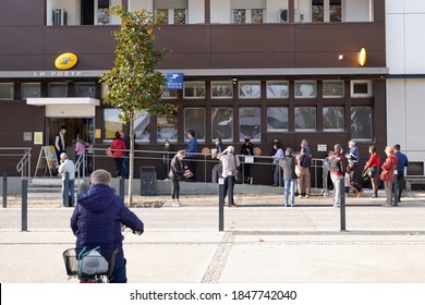 Bordeaux , Aquitaine / France - 10 31 2020 : La Poste French Bank And Post In France People Standing In Line Due Coronavirus Pandemic Safety Guideline COVID 19 Safe Social Distancing 