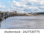 A Bordeaux city in France with a river running through it and a bridge in the background. The water is brown and murky