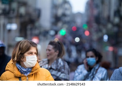 BORDEAUX, FRANCE - FEBRUARY 24 2022: Selective Blur On Old Woman With Facemask, Walking In The Crowded Sainte Catherine Street In Bordeaux During Coronavirus Covid 19.



