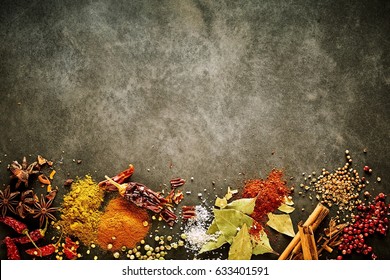 Border Of Assorted Aromatic And Pungent Spices For Asian Cuisine With Star Anise, Chili, Peppercorns, Bay Leaves, Salt, Turmeric Ad Curcuma With Copy Space Above