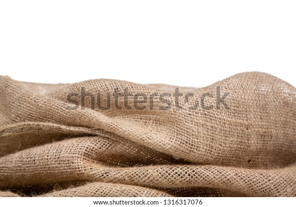 Border of burlap or jute open woven fabric on\
white background.