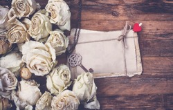 Border Of Dry White Roses, Stack Of Old Postcards Tied With Rope, Key On Chain, On Old Wooden Table, Vintage Retro Style Image