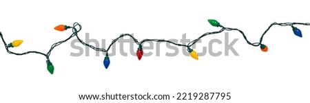 Border of festive colorful holiday light string isolated on white	
