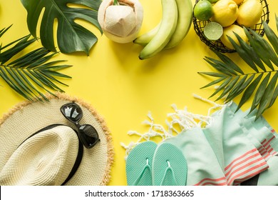 Border Of Outfit Beach Female Accessories. Straw Sunhat, Coconut Drink, Monstera Leaves On Yellow. Tropical Summer Vacations. Top View With Space For Text.