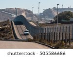 Border Patrol vehicle patrolling along the fence of the international border between San Diego, California and Tijuana, Mexico