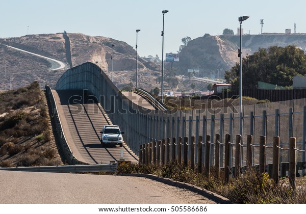Border Patrol vehicle patrolling along the fence\
of the international border between San Diego, California and\
Tijuana, Mexico