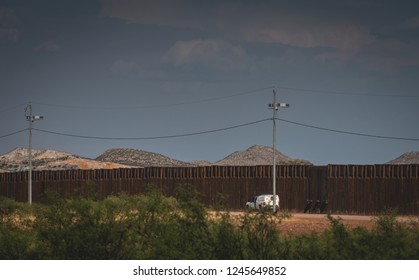 Border patrol waiting on the US side of the fence for illegal immigrants to cross from Mexico