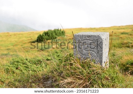 A border stone high in the mountains marking the border with Slovakia. Pre-war Slovak-Ukrainian border. Border marking between states