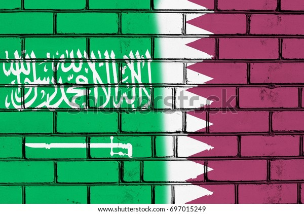 The border\
wall. Two flags. Saudi Arabia.\
Qatar.