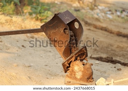 Bore well or known as hand pump in a rustic condition on outdoors. Abandoned hand pump exposed to sunlight
