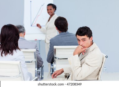 Bored Businessman At A Conference With His Colleagues