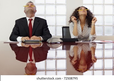 Bored Businessman And Secretary Playing With Pencil And Having Fun In Office Meeting Room. Horizontal Shape, Front View, Waist Up