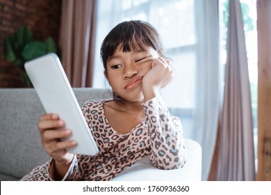 Bored Child Play With Mobile Phone While Staying Home