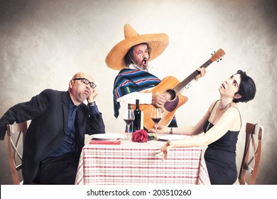 Bored Couple At Dinner Oblyed To Listen To A Mexican Musician