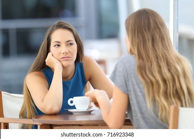 Bored Girl Listening A Bad Conversation Sitting In A Restaurant Terrace