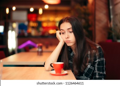 Bored Girl Waiting for her Date in a Coffee Shop. Stood up woman having a bad time alone in the restaurant 
