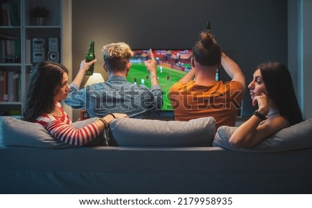 Bored girls talking and gossiping together while their boyfriends are watching soccer on TV Сток-фото © 
