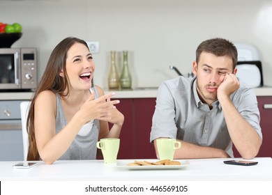 Bored Husband Hearing His Wife Talking During Breakfast In The Kitchen At Home