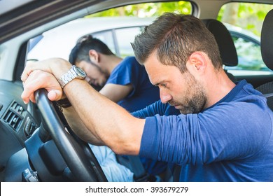 A Bored Man In The Car Stuck In The Traffic. A Couple Of Tired Friend Sitting In The Car And Trying To Rest While Driving To Vacations Destination Or During Any Travel.