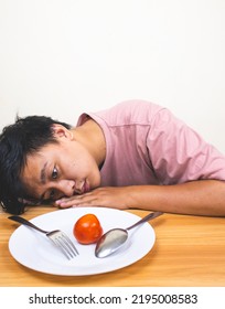 Bored Man Eating Only One Tomato For Diet