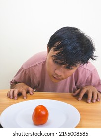 Bored Man Eating Only One Tomato For Diet