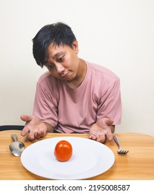 Bored Man Eating Only One Tomato For Diet