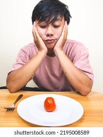 Bored Man Eating Only One Tomato For Diet