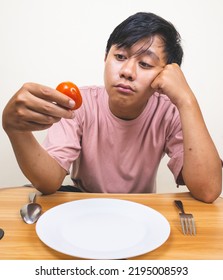 Bored Man Eating Only One Tomato For Diet