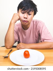 Bored Man Eating Only One Tomato For Diet