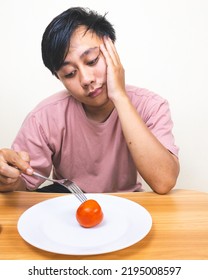 Bored Man Eating Only One Tomato For Diet