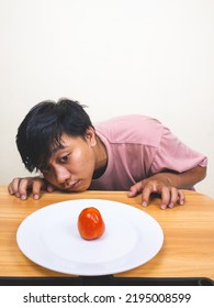 Bored Man Eating Only One Tomato For Diet