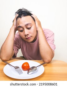 Bored Man Eating Only One Tomato For Diet