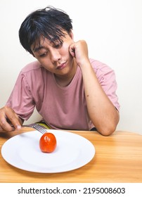 Bored Man Eating Only One Tomato For Diet