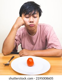 Bored Man Eating Only One Tomato For Diet