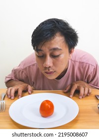 Bored Man Eating Only One Tomato For Diet