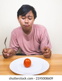 Bored Man Eating Only One Tomato For Diet