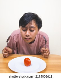 Bored Man Eating Only One Tomato For Diet