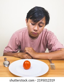 Bored Man Eating Only One Tomato For Diet