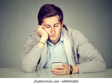 Bored man using his smart phone 