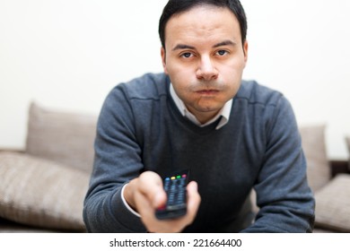 Bored Man Watching Tv On The Sofa