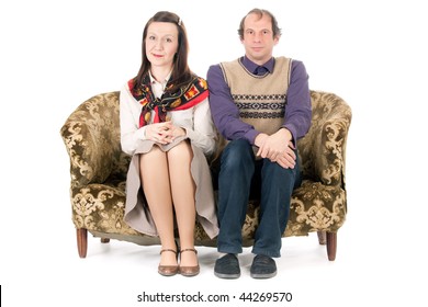 Bored  Old Looking Couple Sitting On Vintage Couch Isolated On White