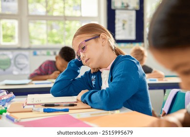  Bored schoolgirl tired of learning and doing homework while trying not to fall asleep, attention deficit, lack of concentration and distraction concept. Little girl wearing spectacles feeling bored. - Powered by Shutterstock